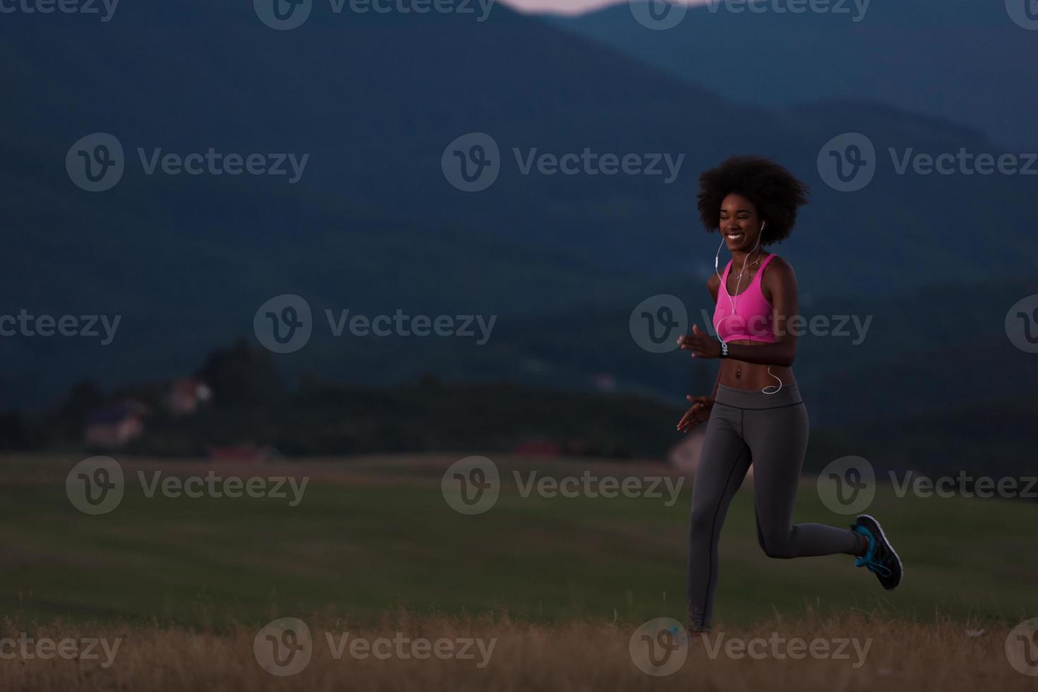 Young African american woman jogging in nature photo