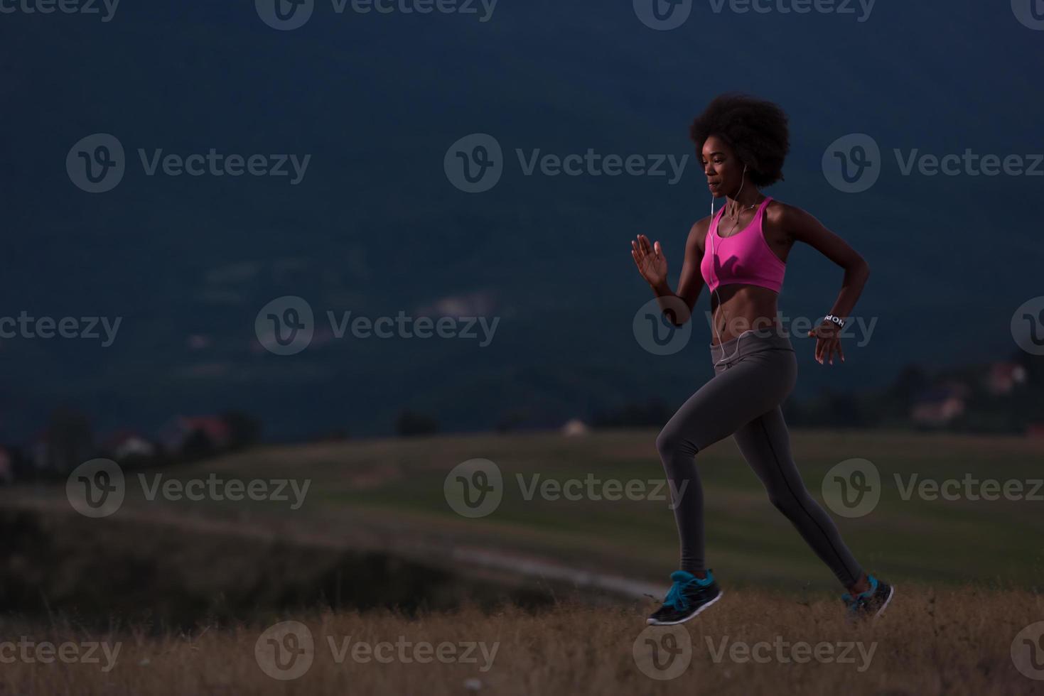 Young African american woman jogging in nature photo