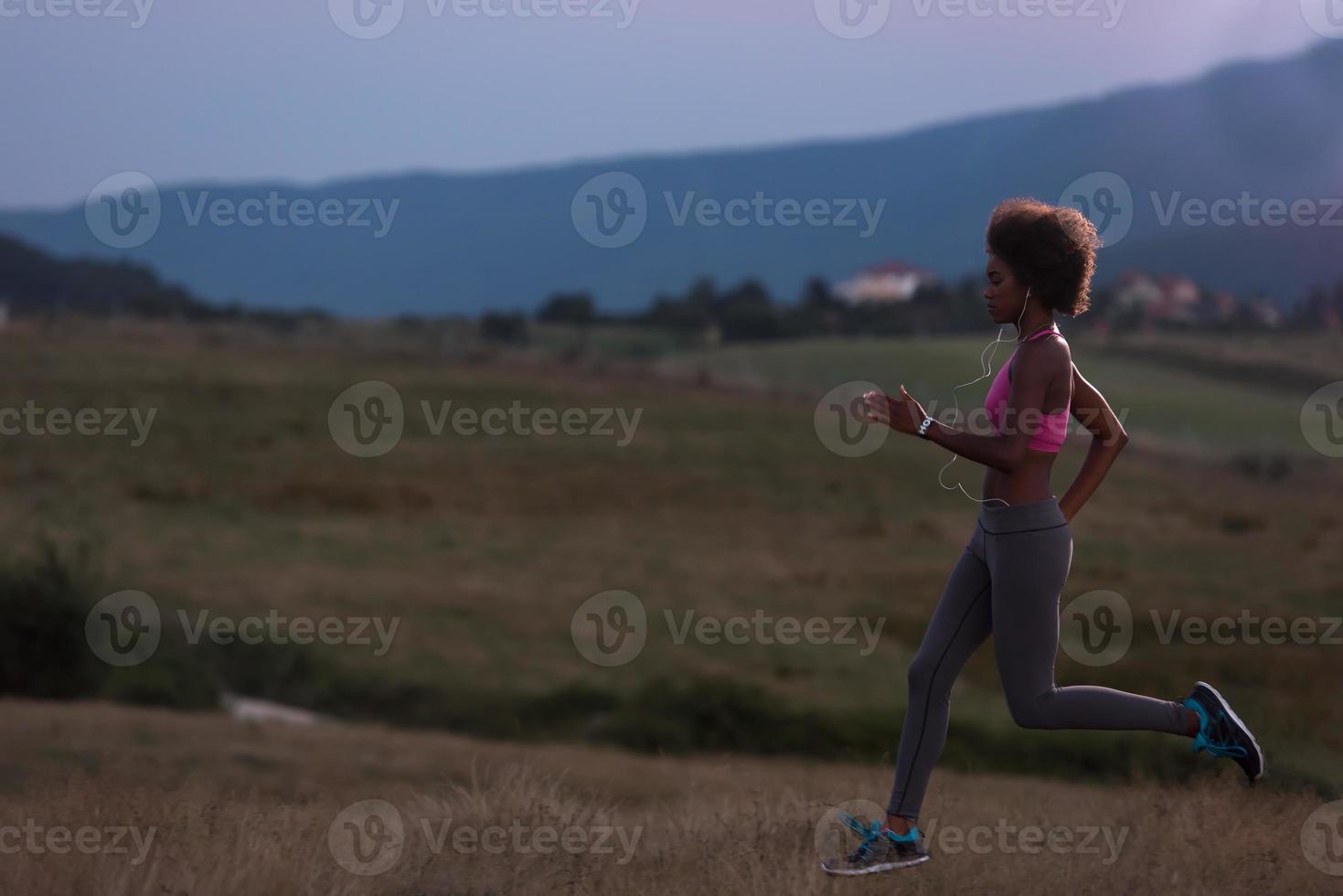 Young African american woman jogging in nature photo