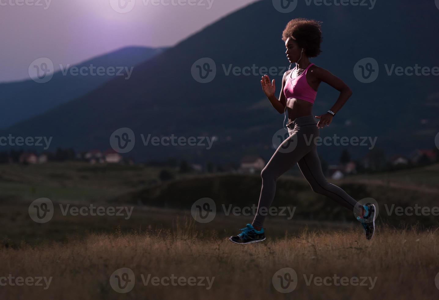 Young African american woman jogging in nature photo