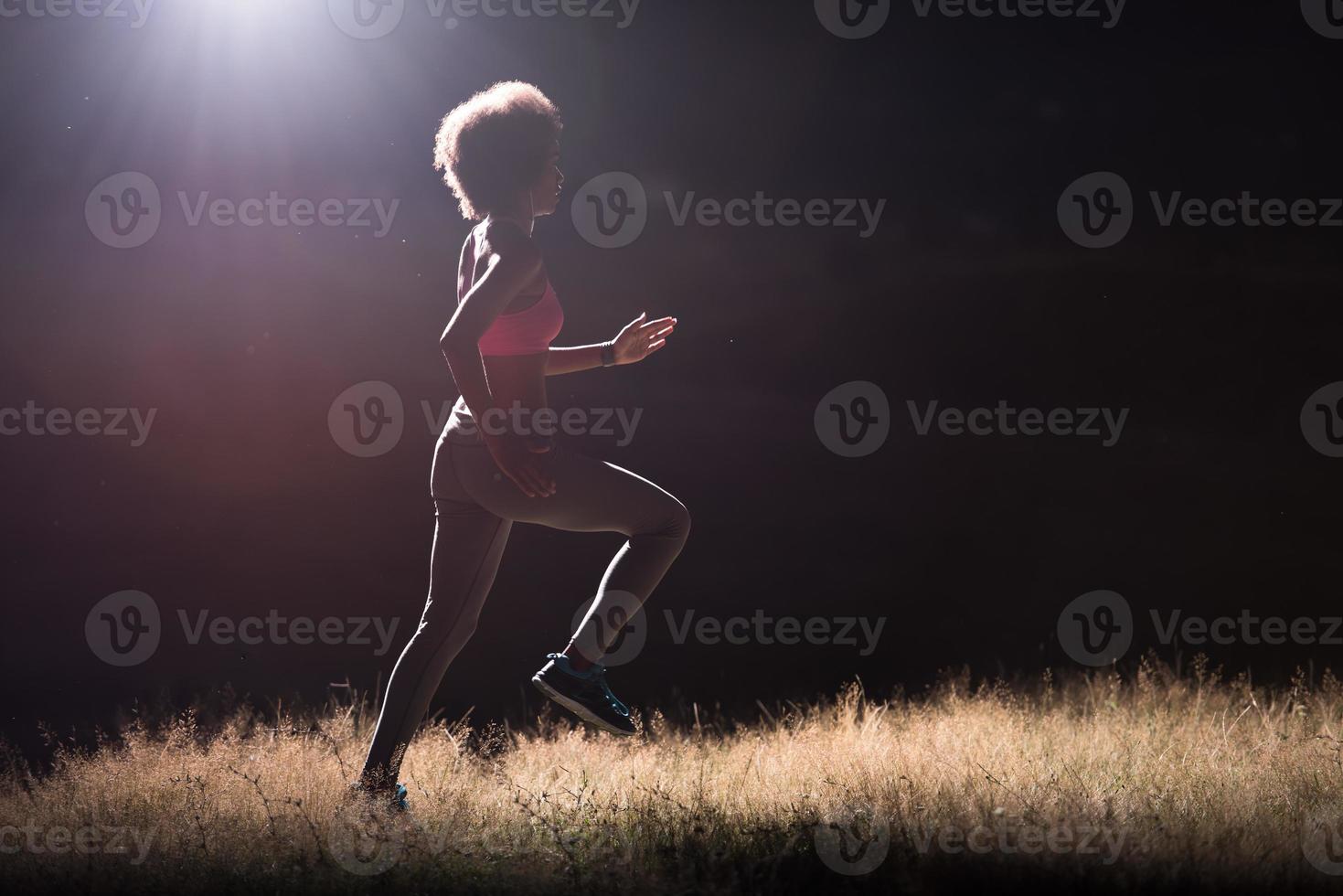 Young African american woman jogging in nature photo