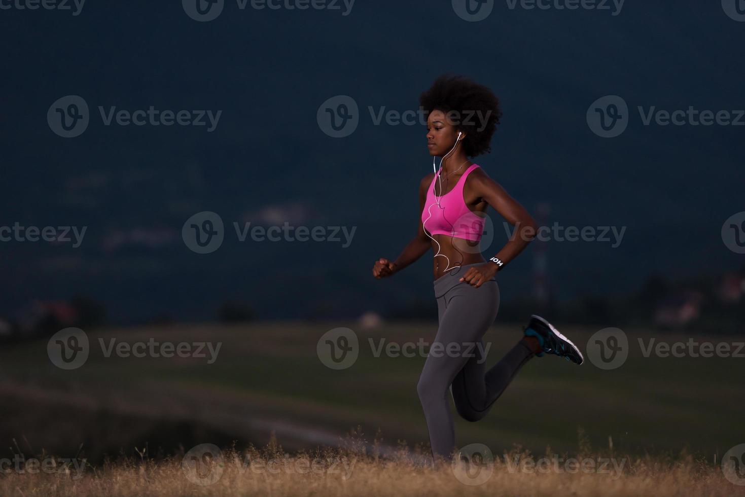 Young African american woman jogging in nature photo