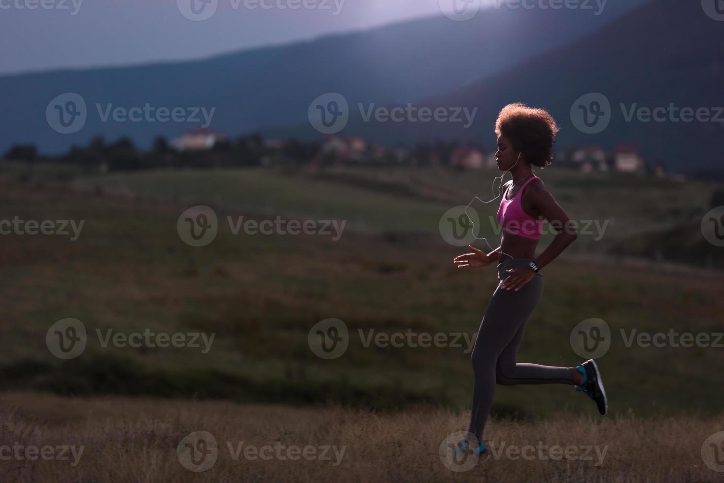 Young African american woman jogging in nature photo