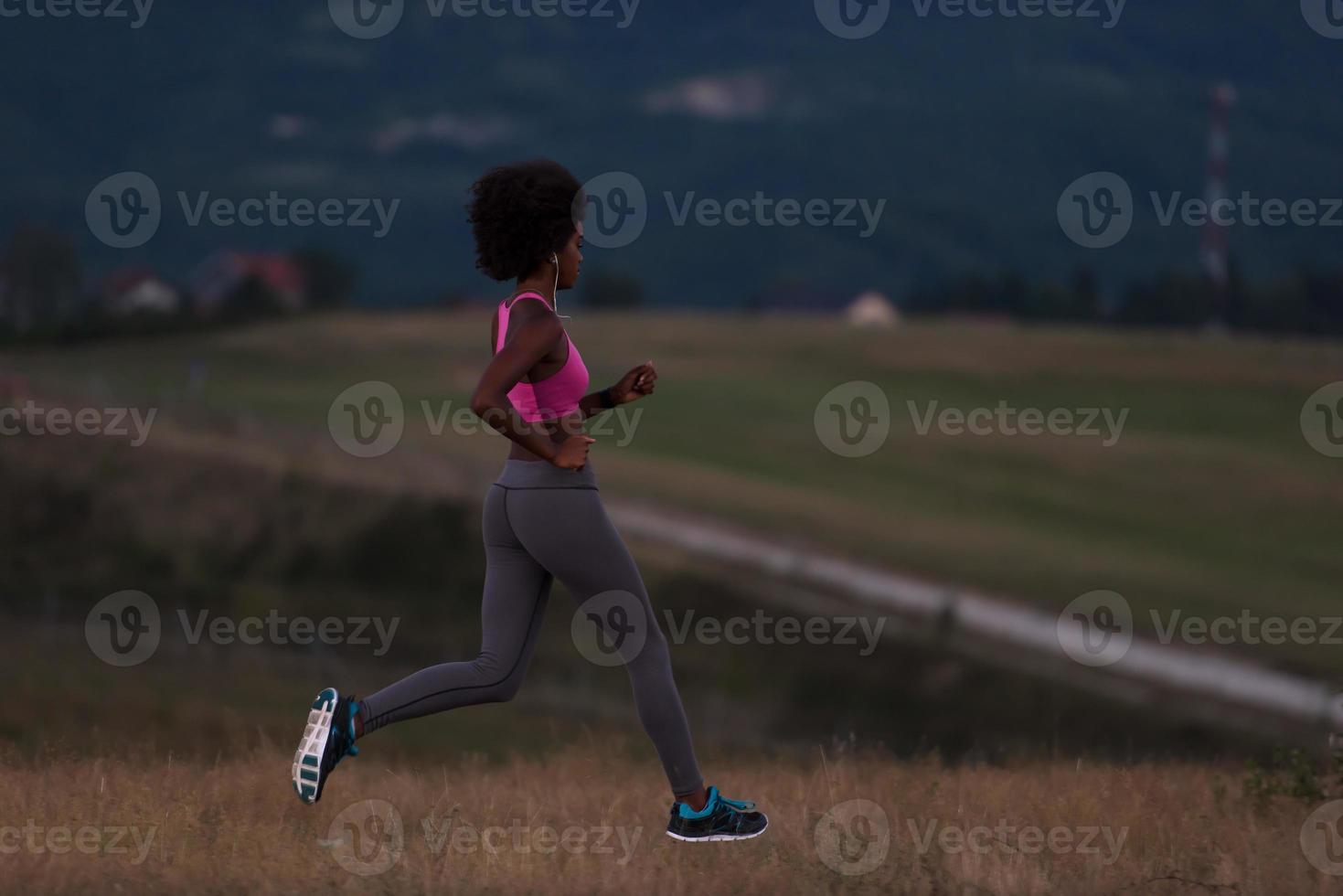 Young African american woman jogging in nature photo