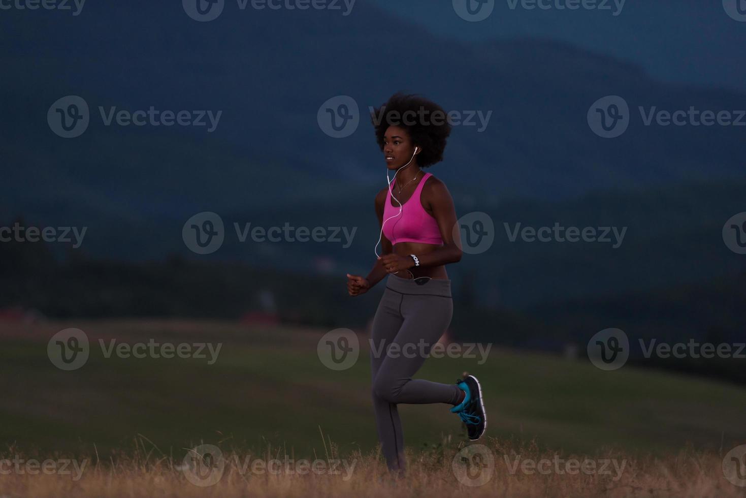 Young African american woman jogging in nature photo