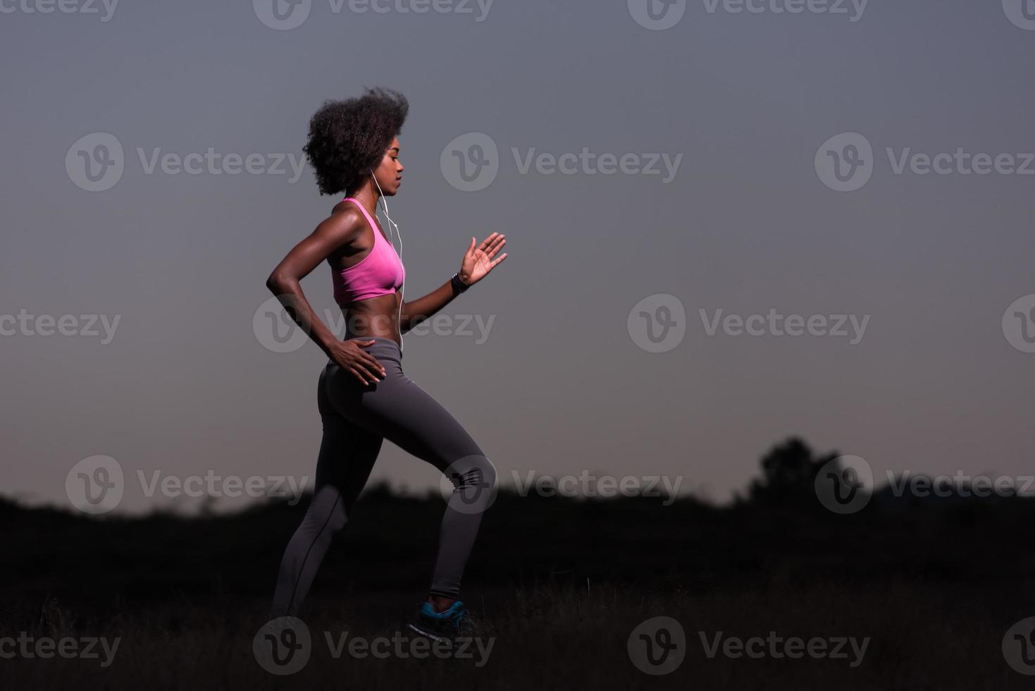 Young African american woman jogging in nature photo