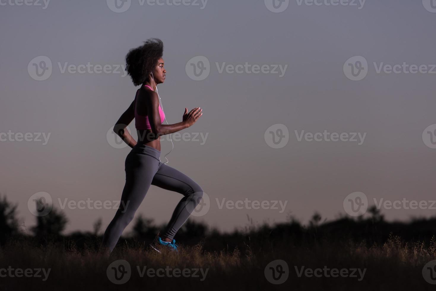 Young African american woman jogging in nature photo