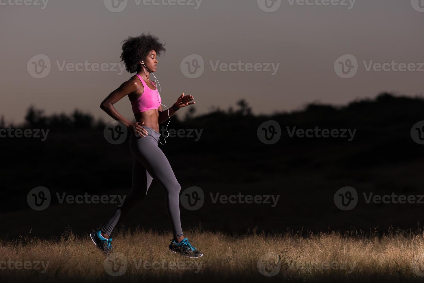 Young African american woman jogging in nature photo