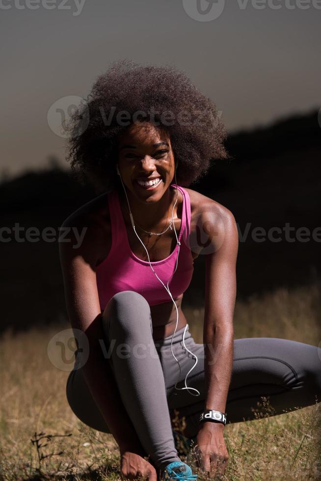 black woman runner tightening shoe lace photo