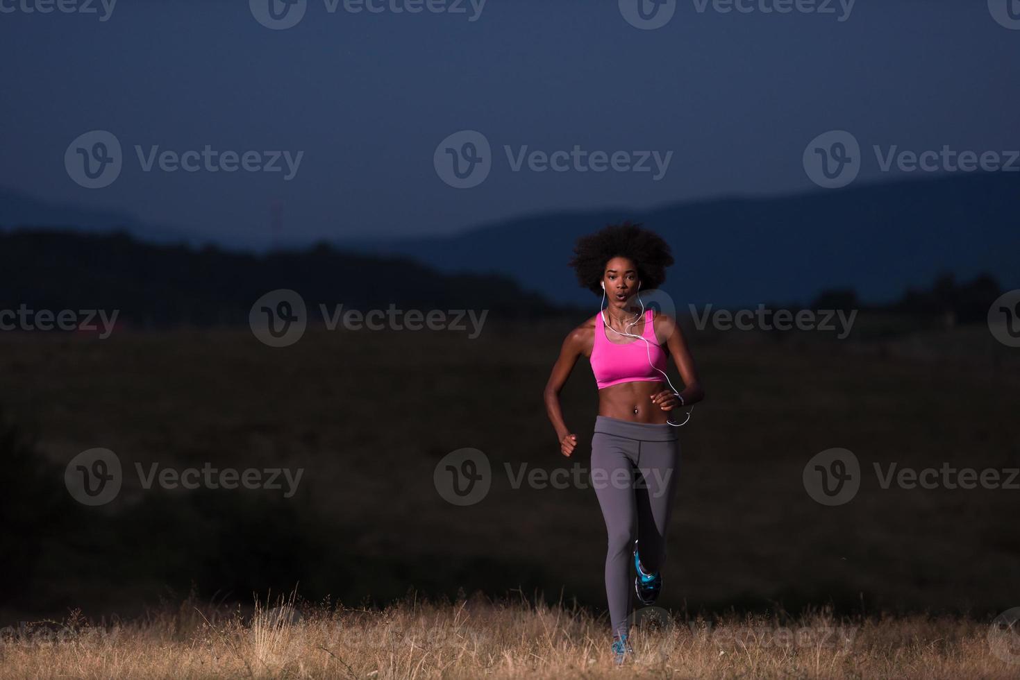 Young African american woman jogging in nature photo