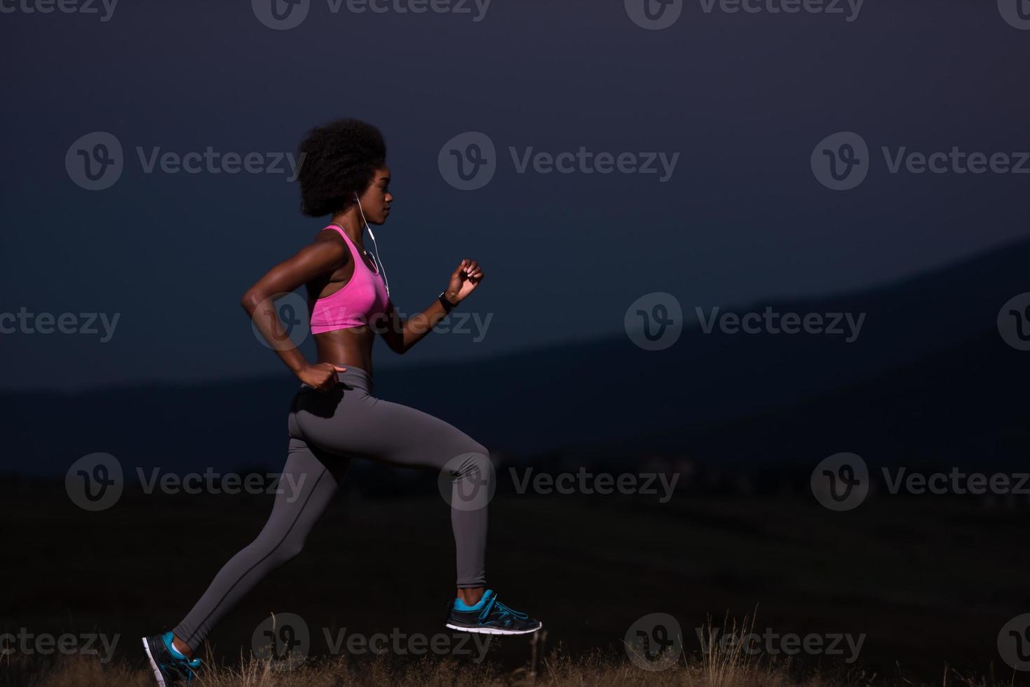Young African american woman jogging in nature photo