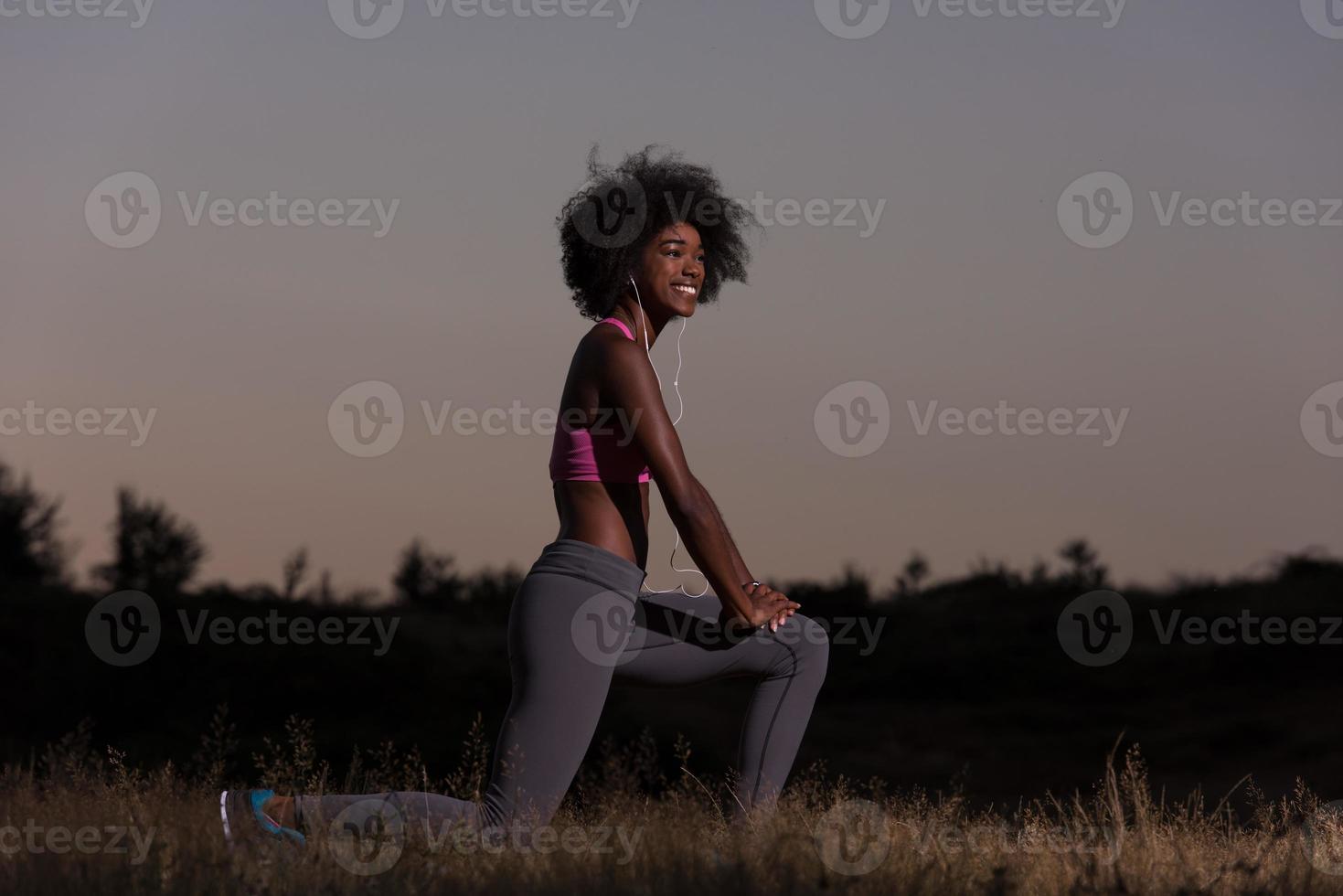 black woman is doing stretching exercise relaxing and warm up photo