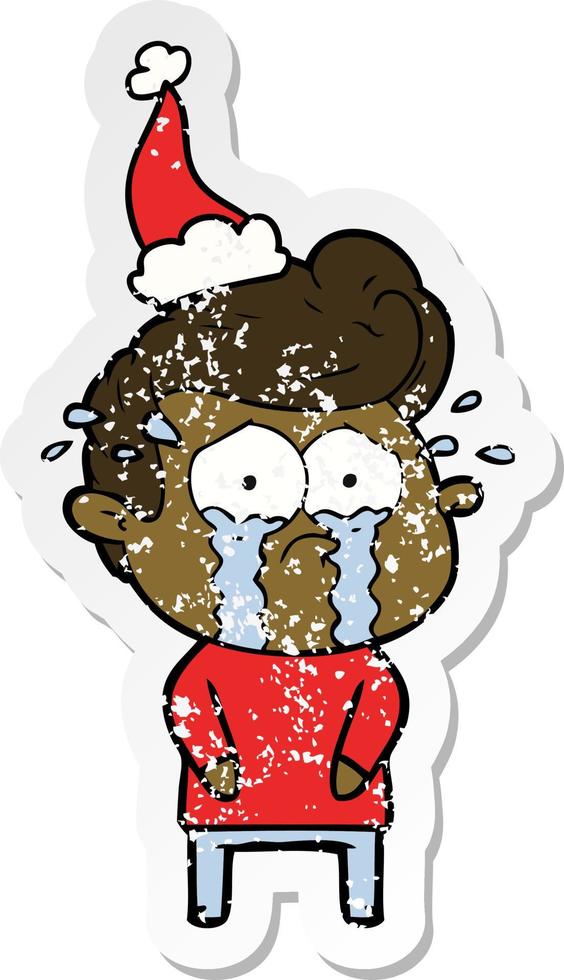 distressed sticker cartoon of a crying man wearing santa hat vector