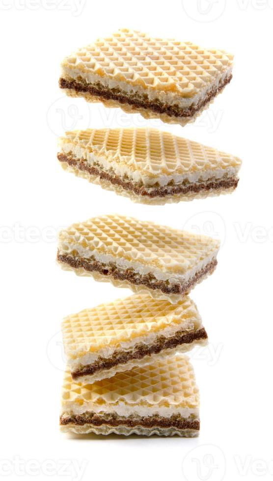 Levitating waffles are isolated on a white background. Delicious crisp waffles. photo