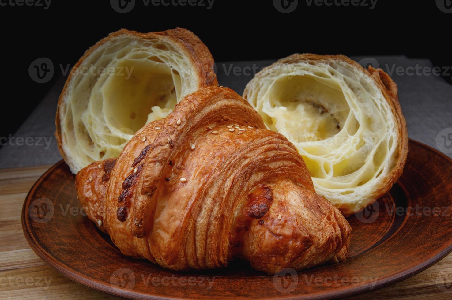 Croissants on a ceramic dish. Fresh pastries. photo