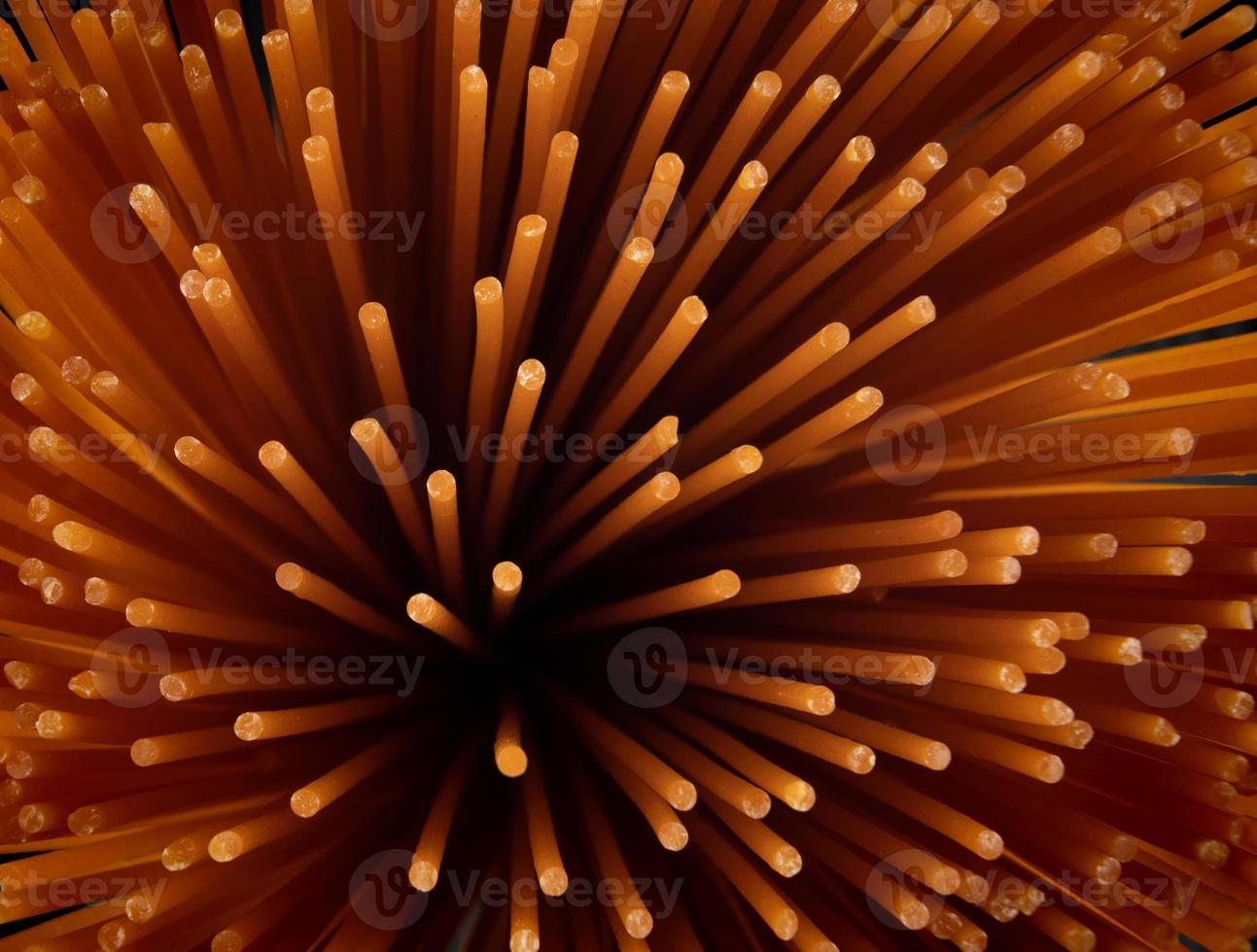 Tomato pasta makes a beautiful pattern. Background from red spaghetti. photo