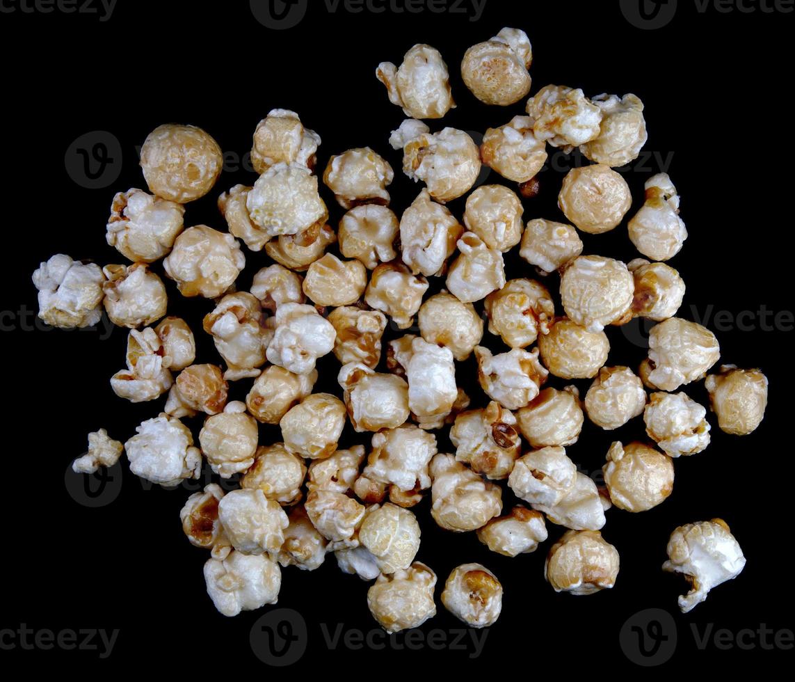 Popcorn is scattered on a black background. Popcorn background. photo