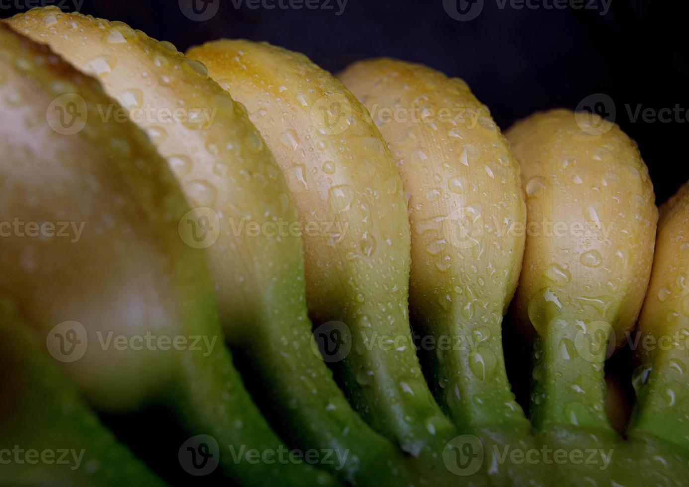 Bunch of bananas with drops of water on the peel. photo