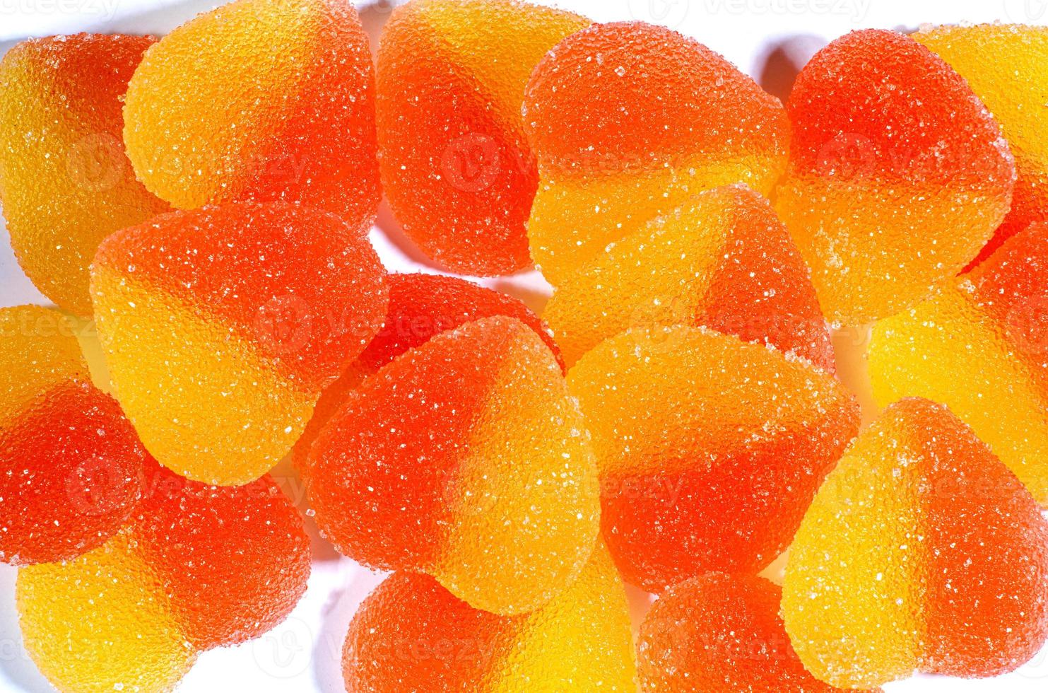 Background of many marmalade hearts on white. Heart-shaped candy. photo