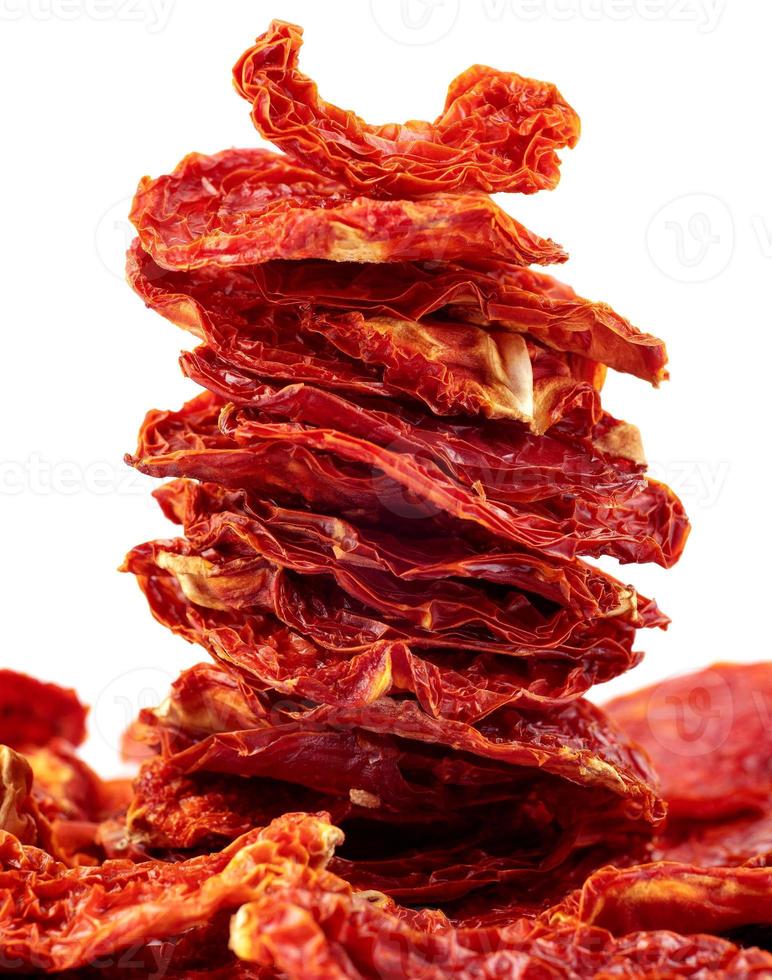 A stack of sun-dried tomatoes is isolated on a white background. photo