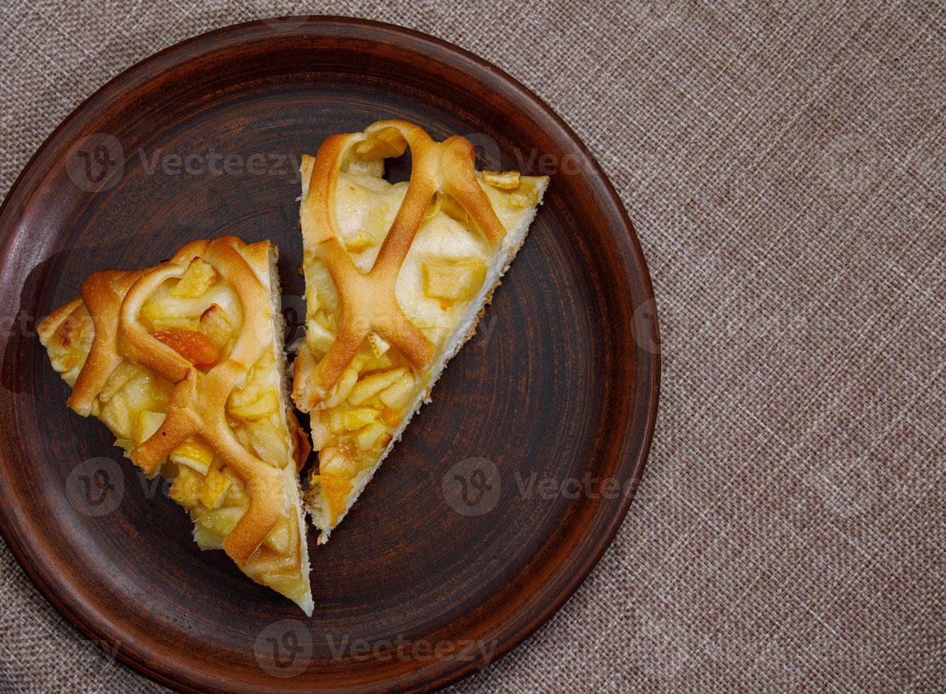 Two pieces of apple pie on a beautiful ceramic plate. a top view. photo