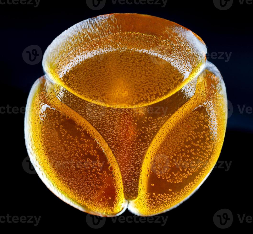 Beautiful yellow marmalade candy is isolated on a black background. photo