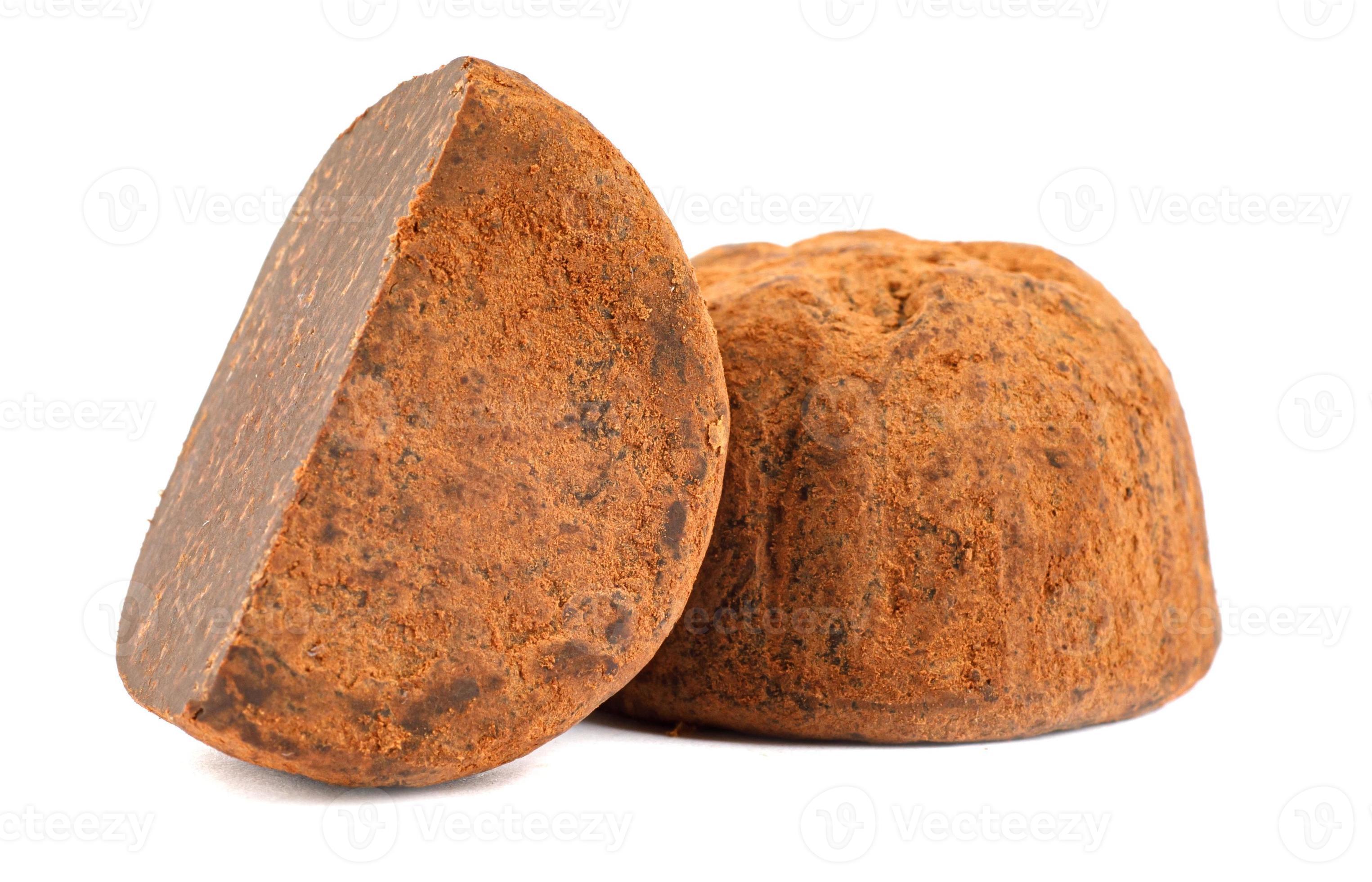 Chocolate truffles are whole and half are isolated on a white