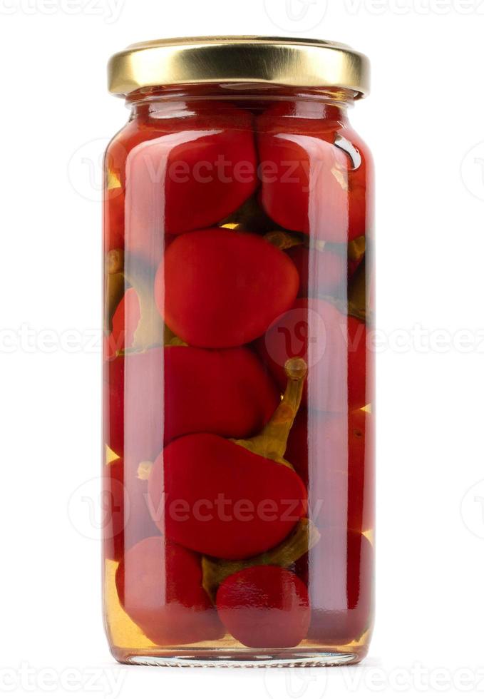 A glass jar with ripe preserved peppers is isolated on a white background. Full clipping path. photo