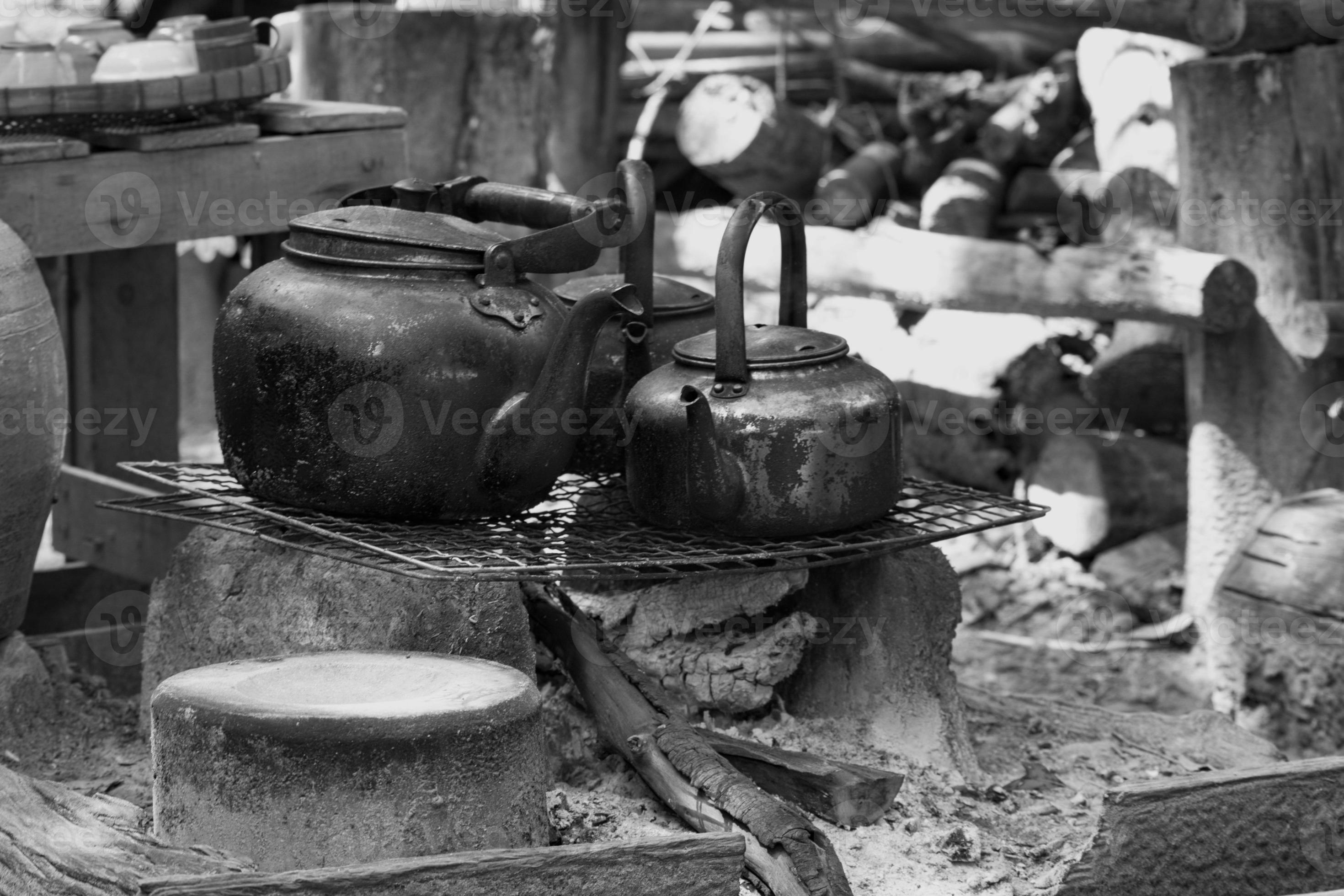 Metal kettle. Oldfashioned boiling water uses firewood to make a fire. Black and White