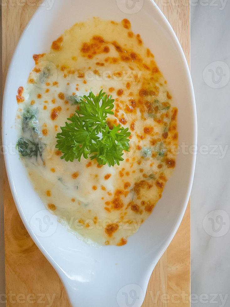 Spinach with cheese in white bowl on wood plate  Flat Lay image. photo