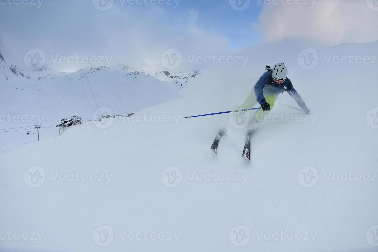 skiing on fresh snow at winter season at beautiful sunny day photo