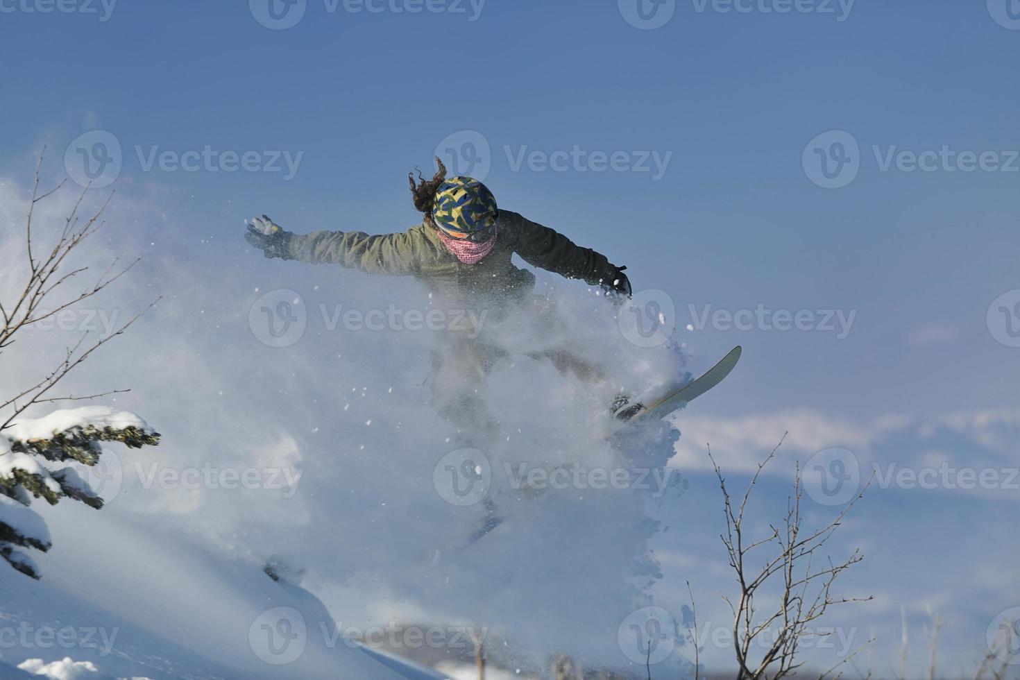 freestyle snowboarder jump and ride photo