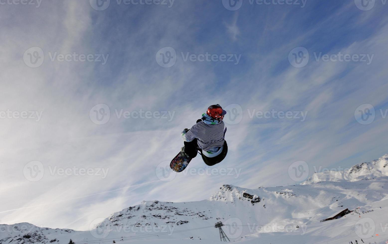 happy young man have fun at winter on mountain peak photo