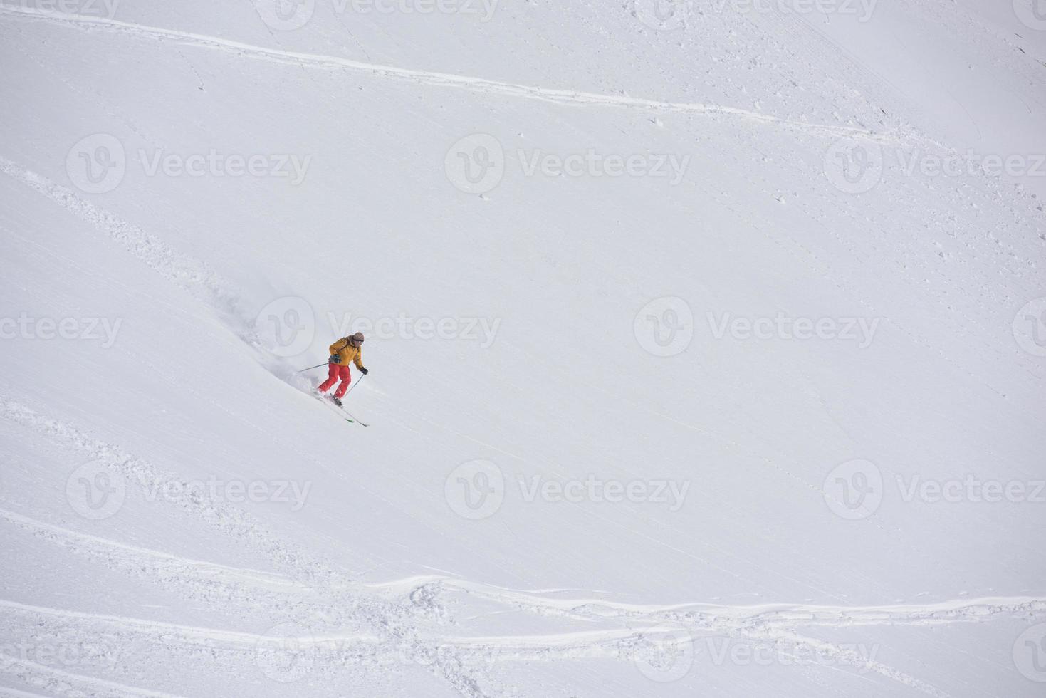 freeride skier skiing in deep powder snow photo