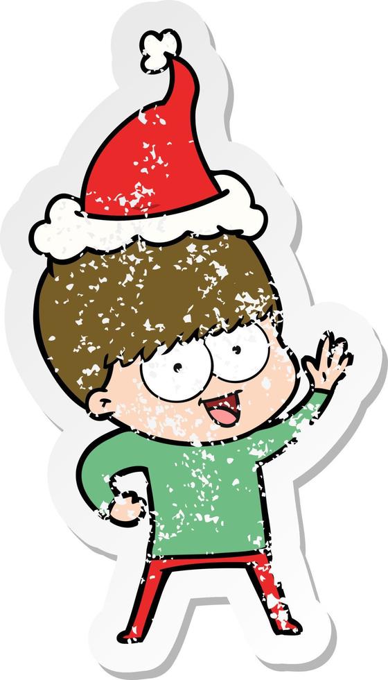 happy distressed sticker cartoon of a boy wearing santa hat vector