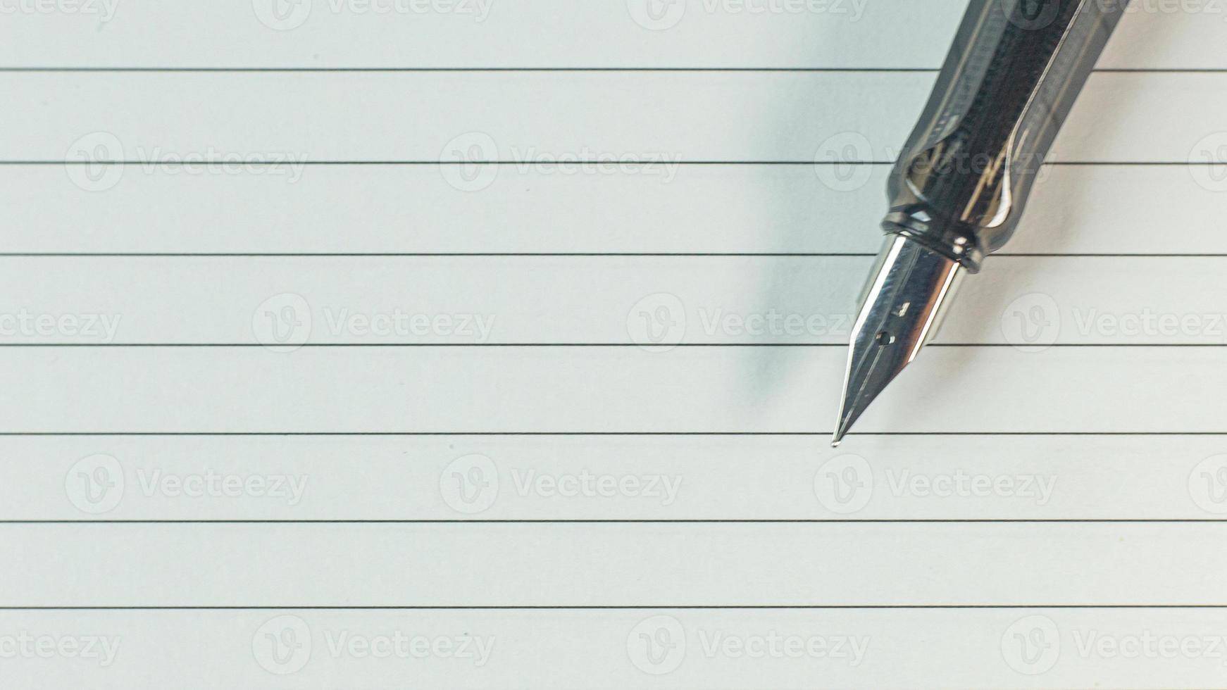 silver pen on wood table for business  content. photo