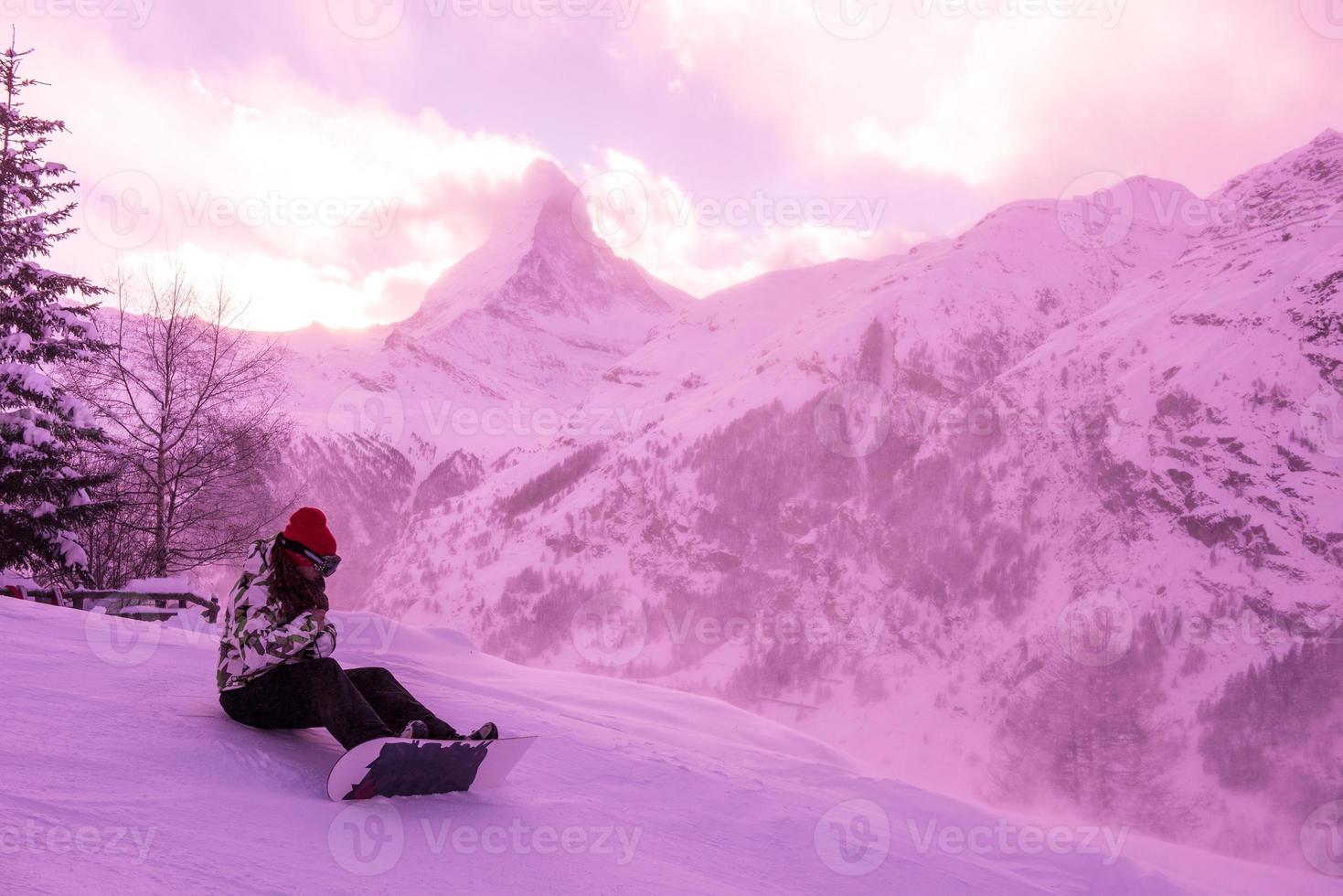 rescue team with a red helicopter rescuing a hurt skier photo