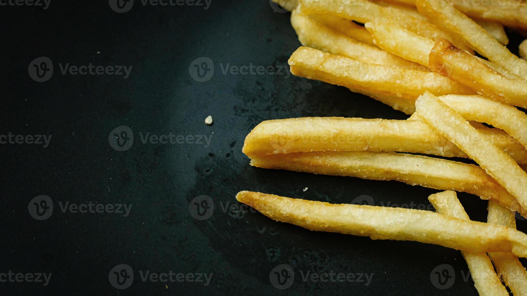 French fries on black plate for food content. photo