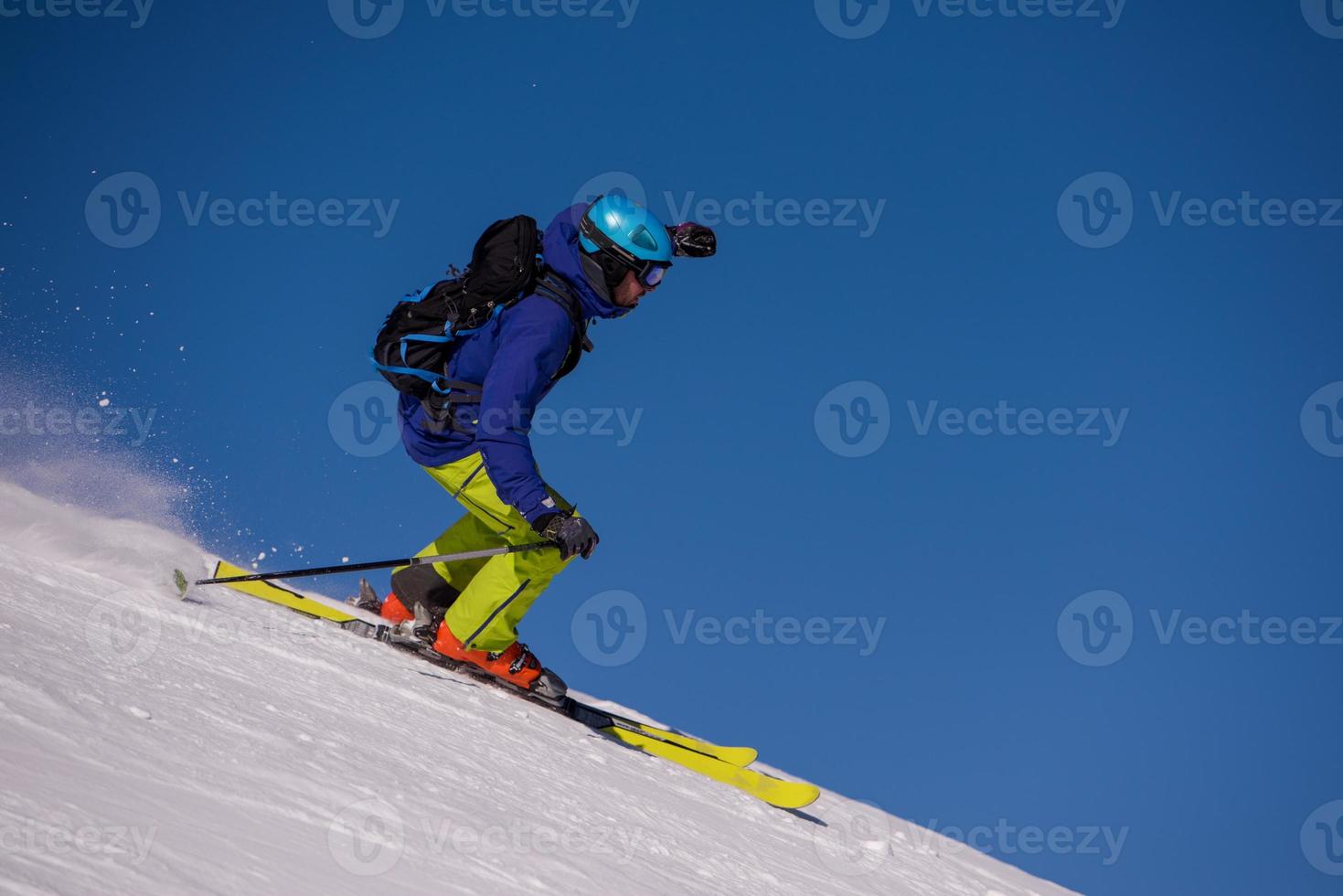 Skier having fun while running downhill photo