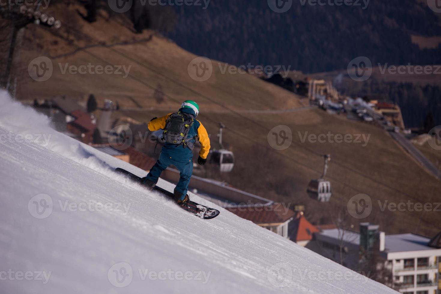 snowboarder running down the slope and ride free style photo