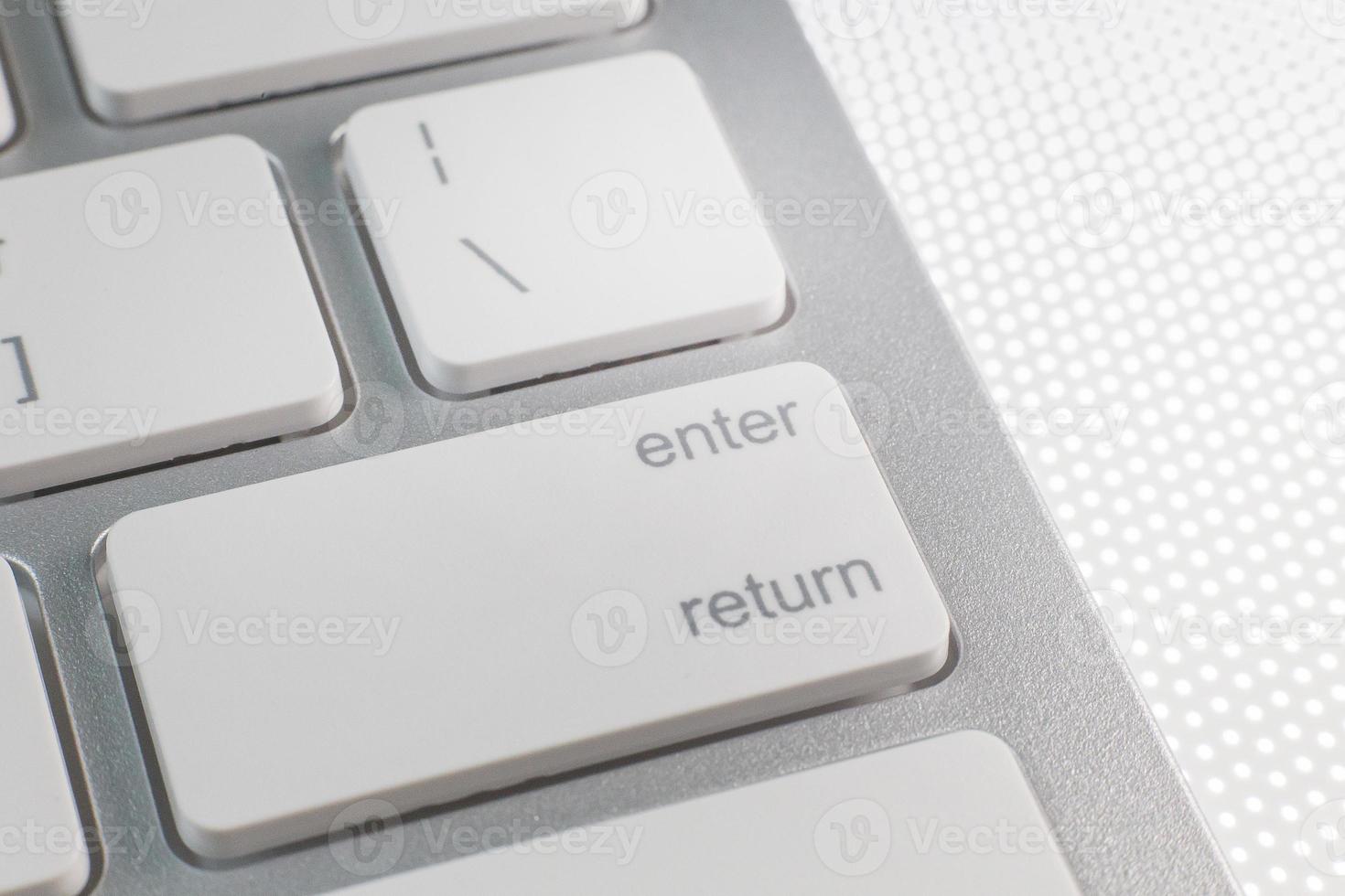 The enter silver modern keyboard close up image. photo