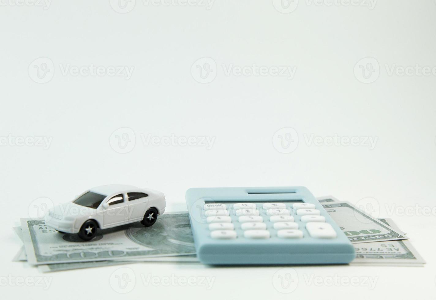 white car toy and blue calculator white background. photo