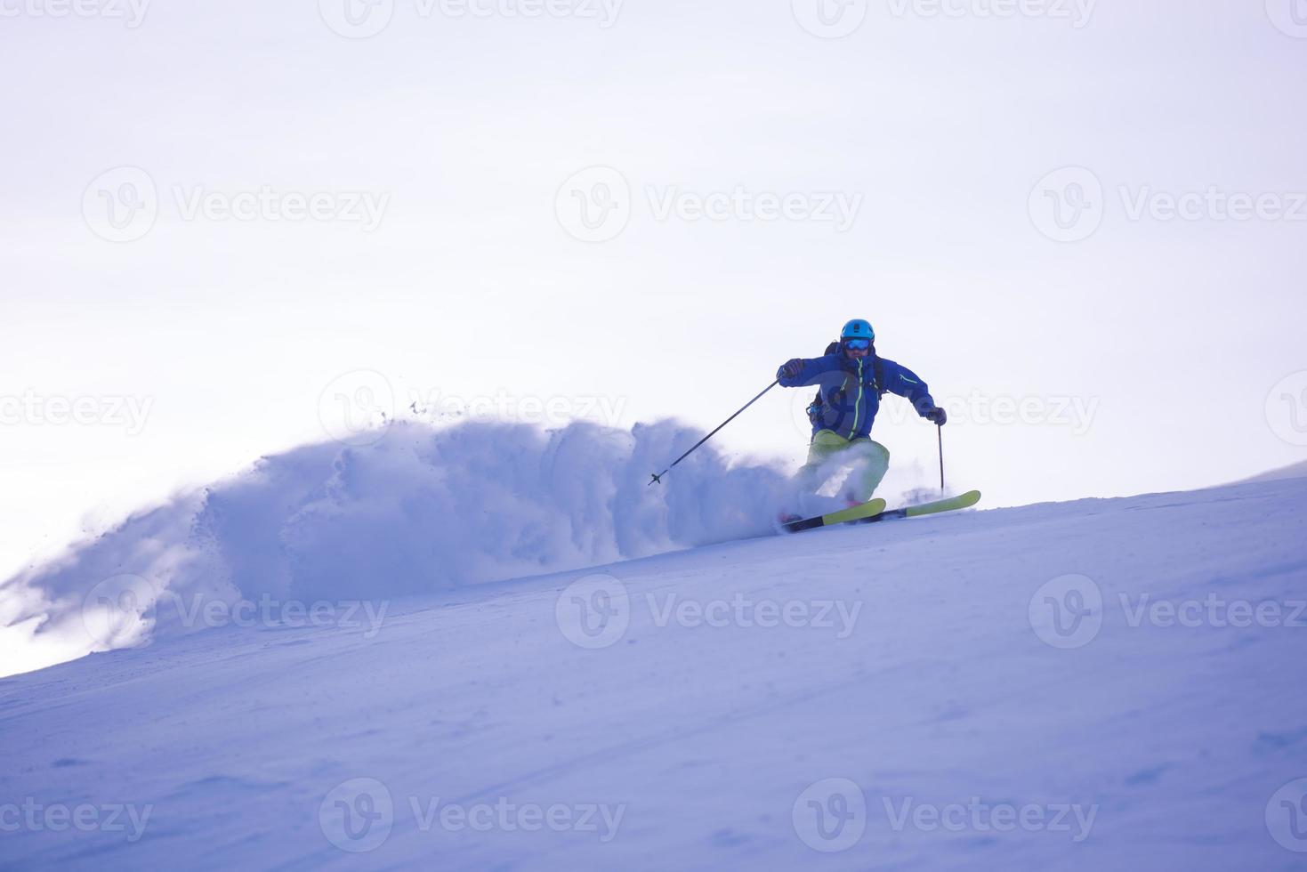 Skier having fun while running downhill photo