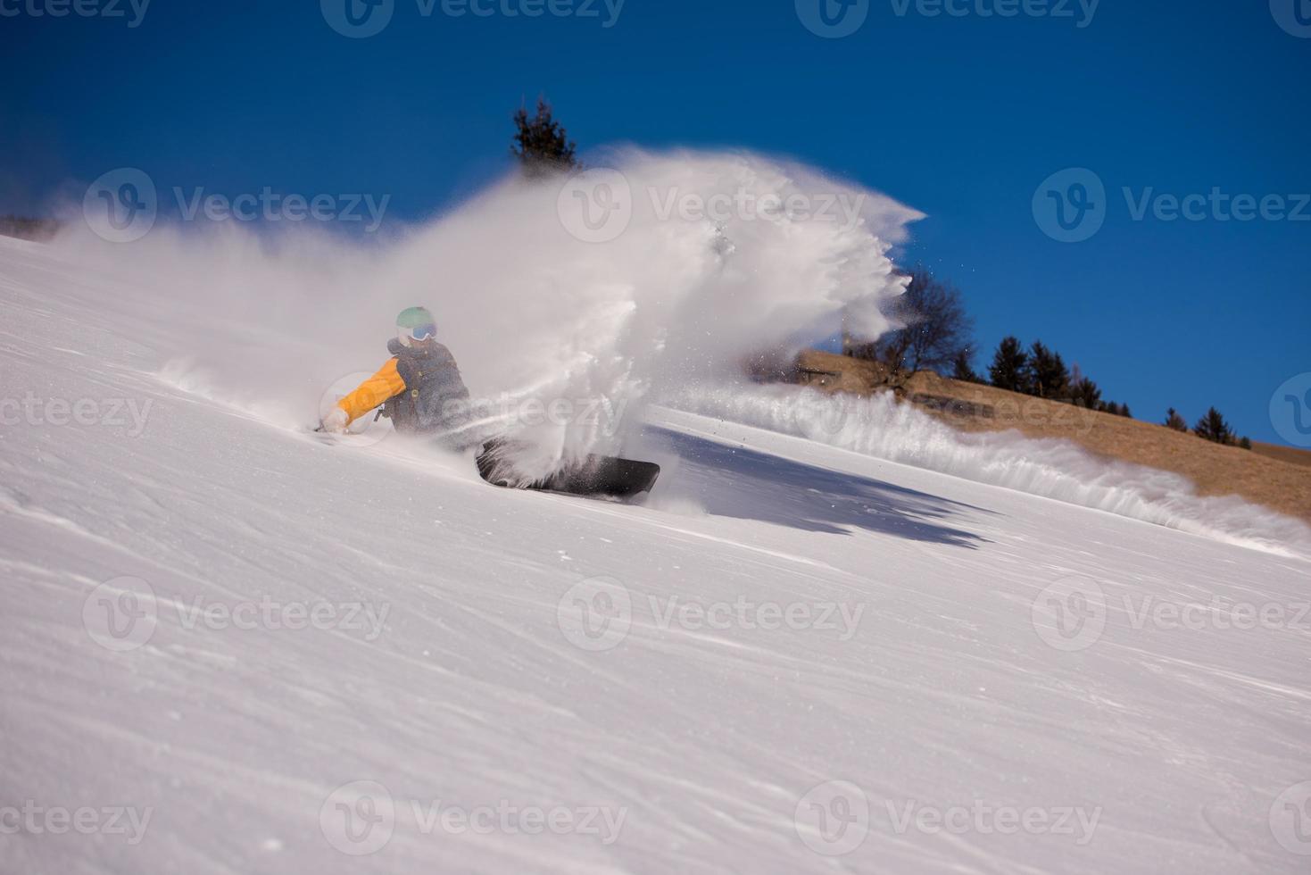 snowboarder crashes while carving down photo