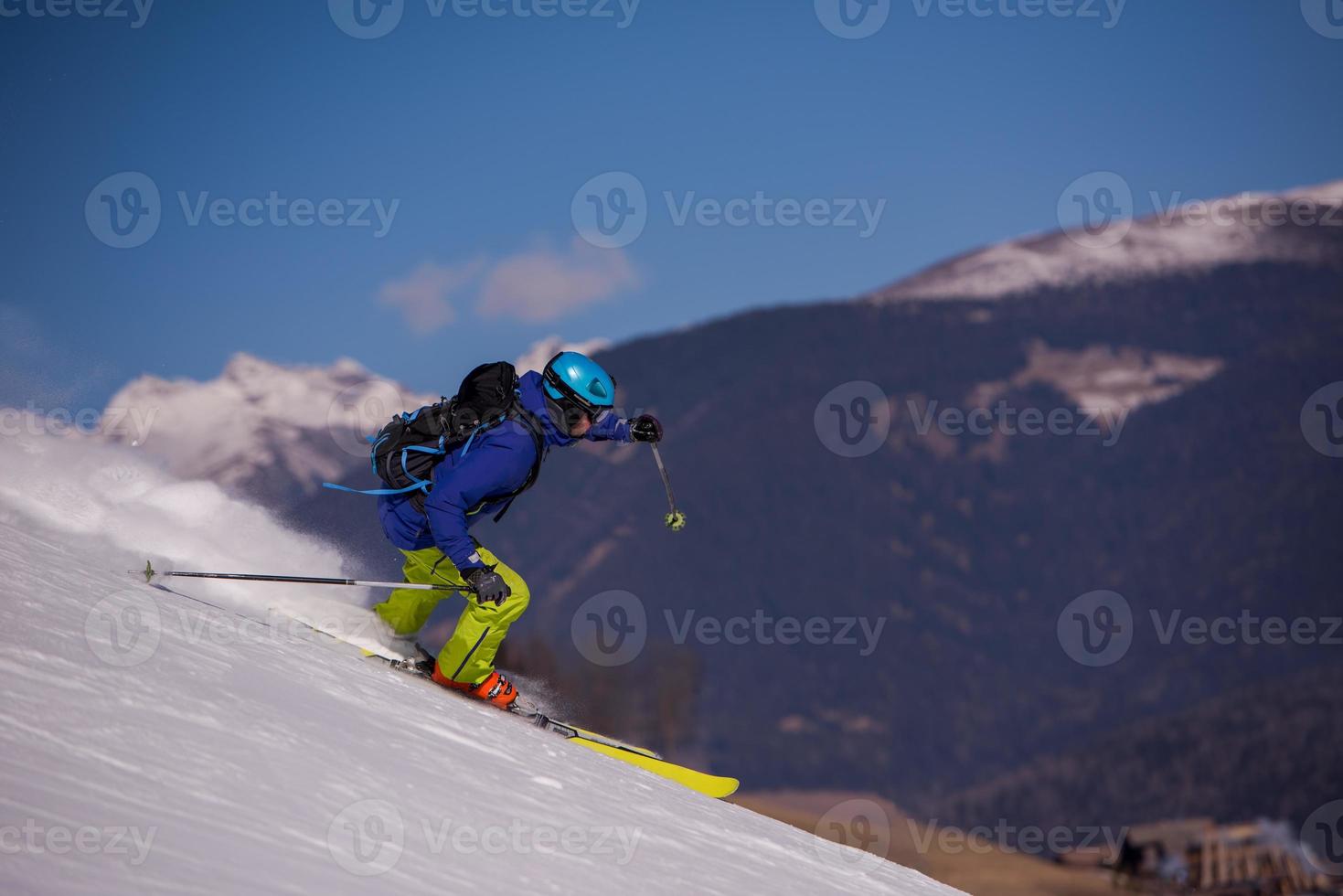 Skier having fun while running downhill photo