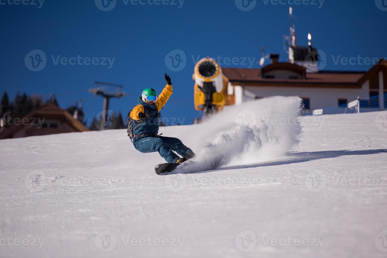 snowboarder running down the slope and ride free style photo