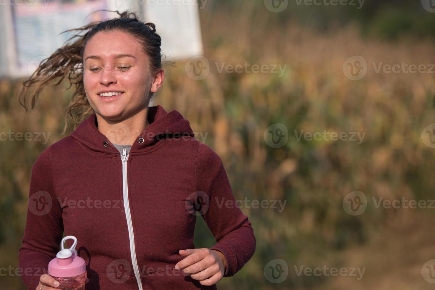 woman jogging along a country road photo