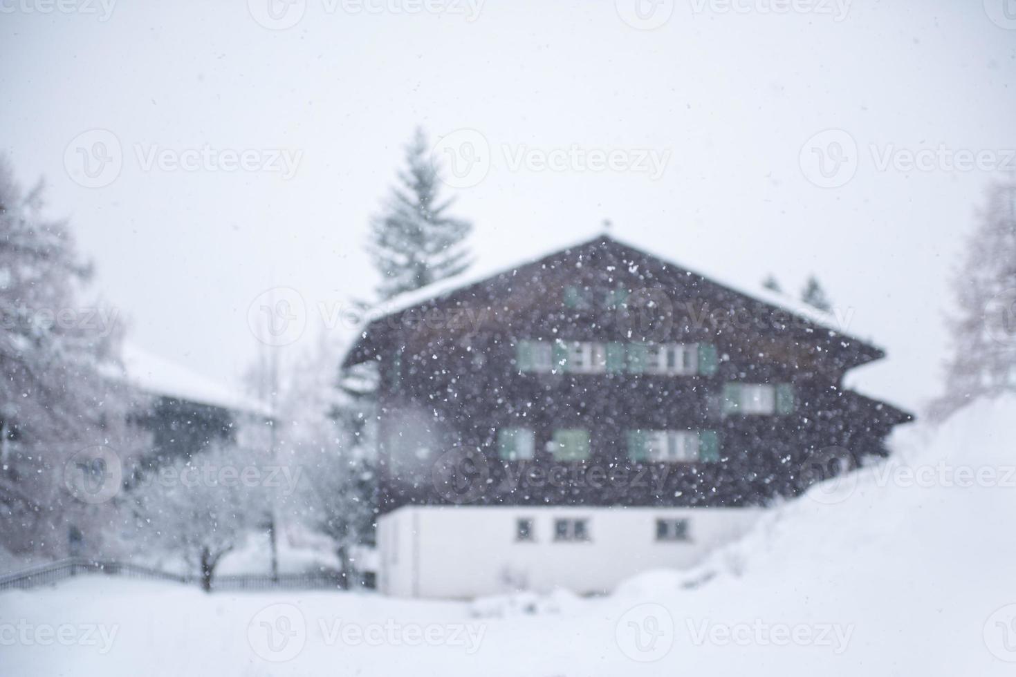 mountain house in snowstorm photo