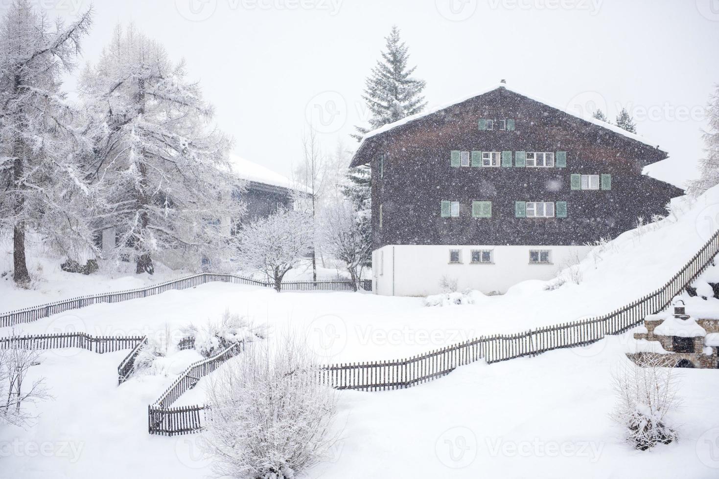 mountain house in snowstorm photo