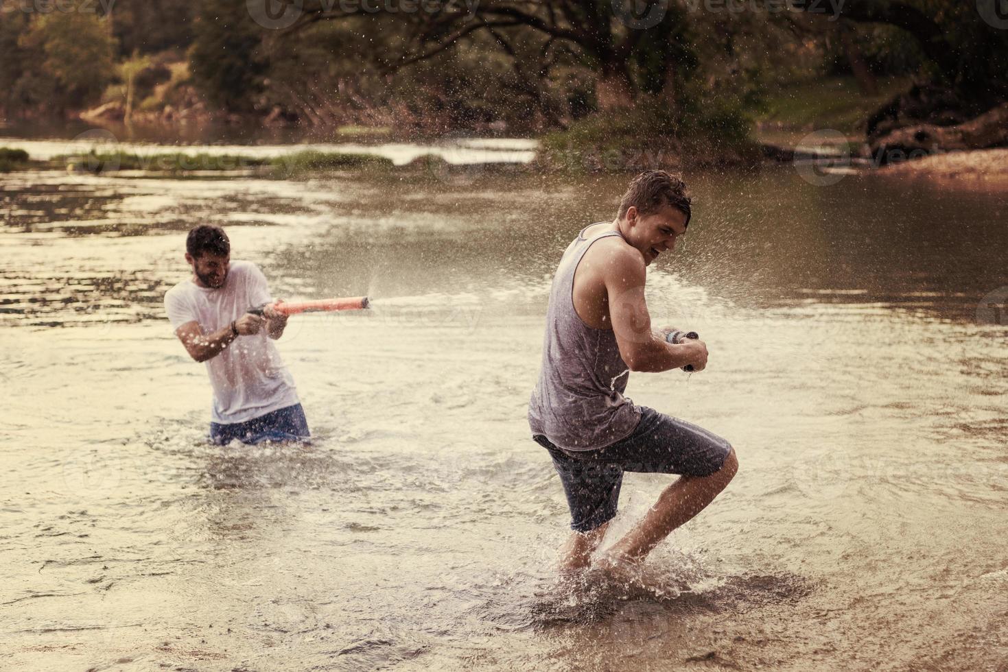 young men having fun with water guns photo